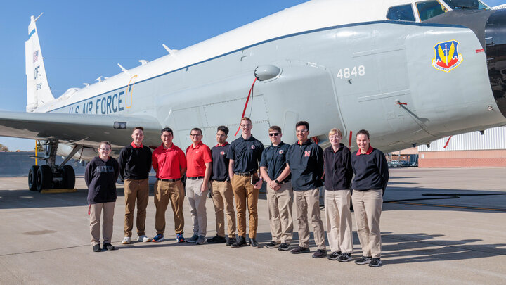 Cadets at Offutt AFB, Nebraska, for a tour standing in front of an RC-135