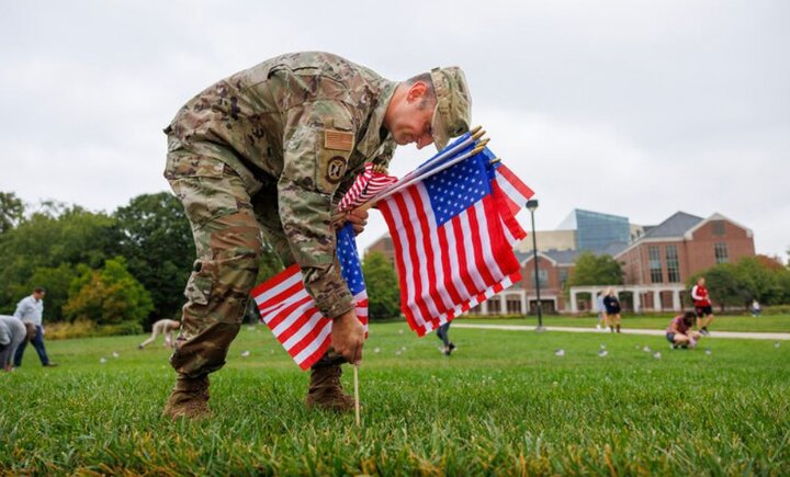 Craig Chandler | University Communication and Marketing Air Force Lt. Col. Phil Garito plants American flags around a section of the green space north of the Nebraska Union.