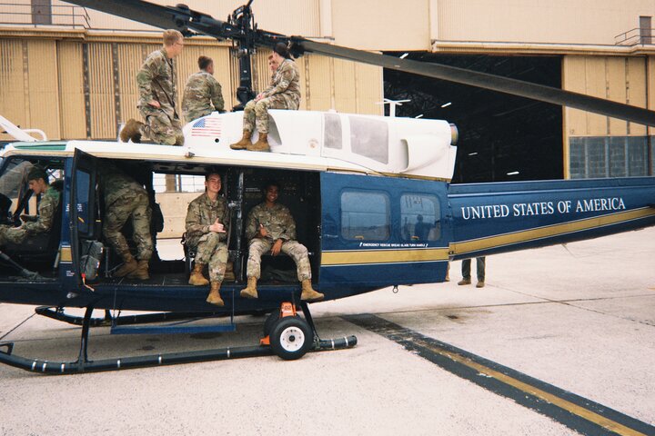 AFROTC cadets sitting in a helicopter in uniform during a capstone event after Field Training